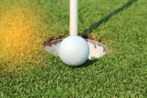 golf ball on lip of cup